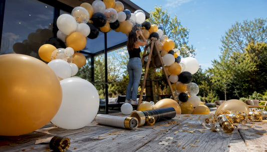 Een half afgemaakte ballonnenboog staat midden in de woonkamer.